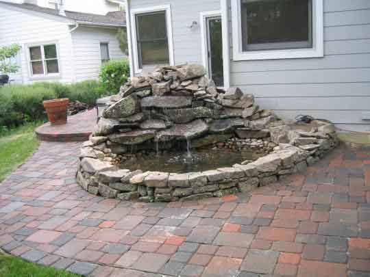 Paver walkway with a sweet rock pond